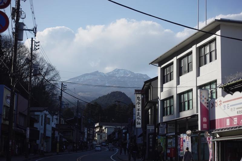 Street with mountains in the background in Nikko