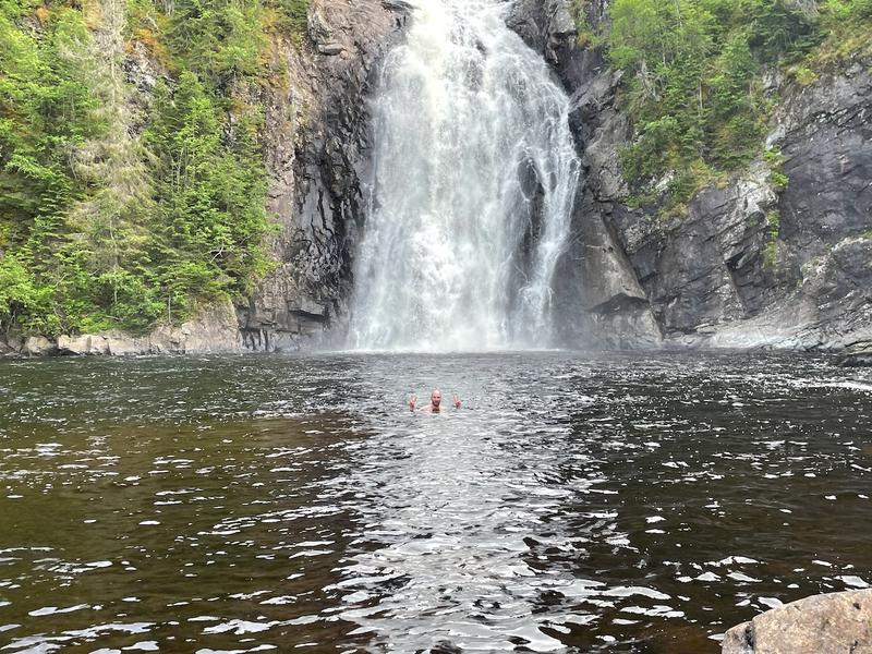 Me swimming in front of waterfall